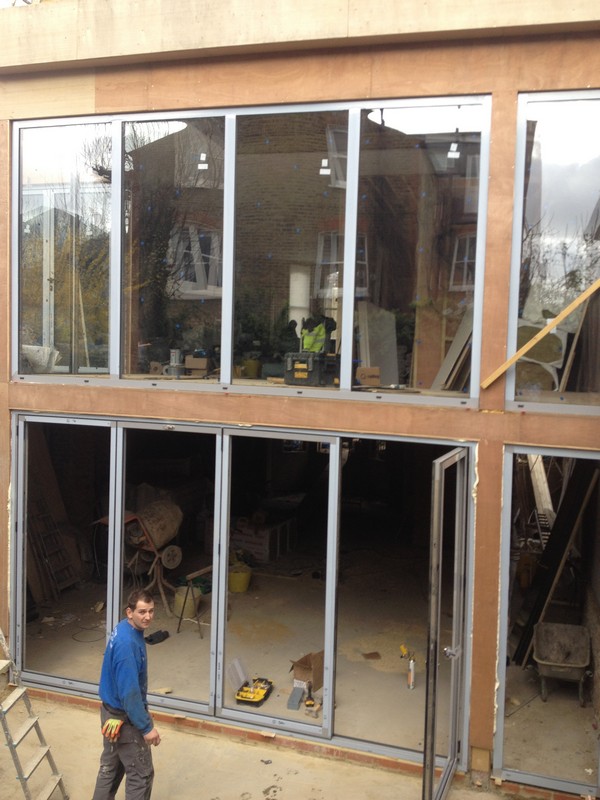 Aluminium bi-fold doors with two-storey glazing in Wimbledon