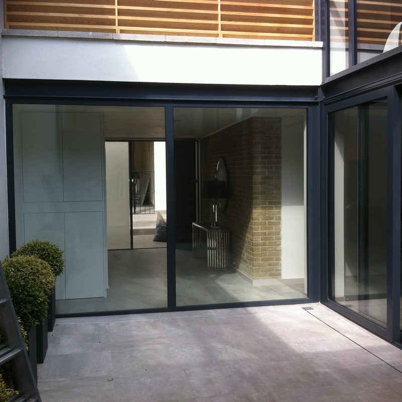 Floor-to-ceiling sliding doors opening to courtyard in Wimbledon