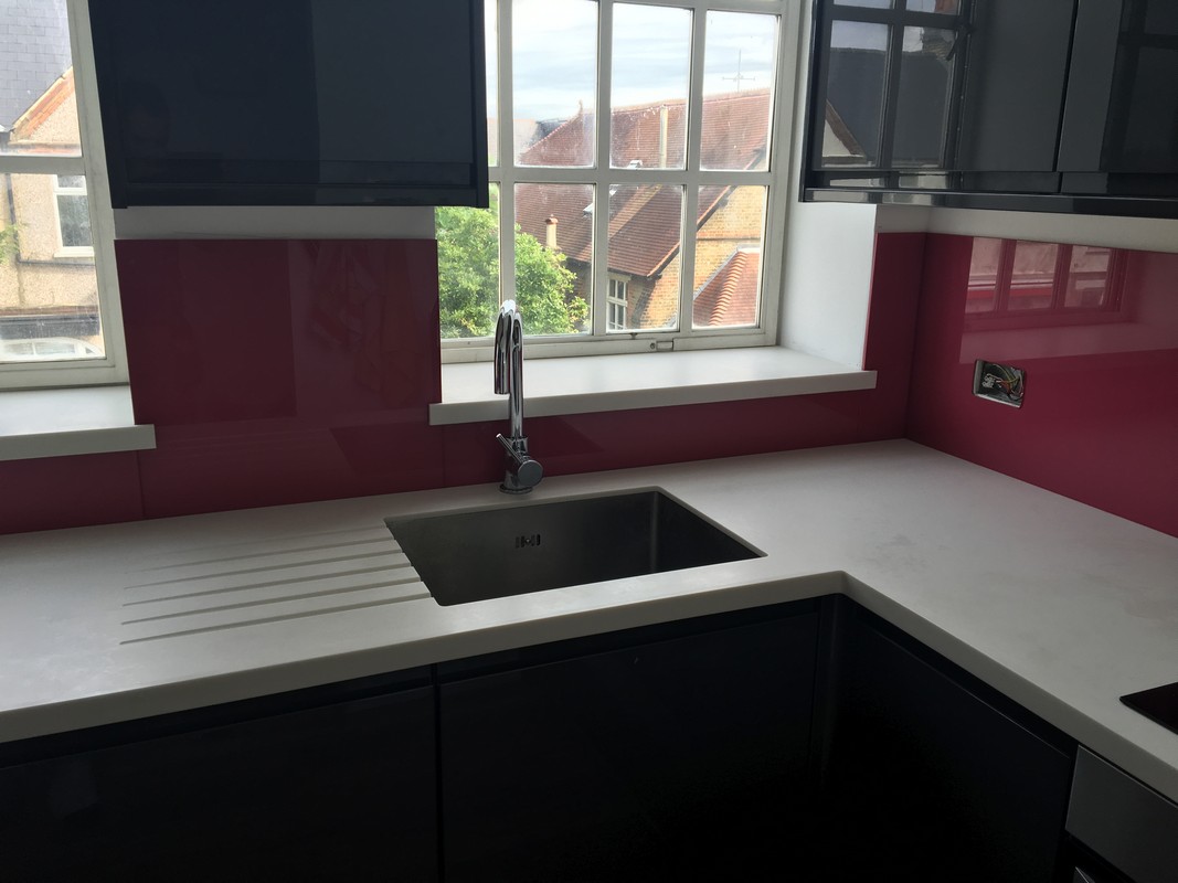 Deep plum coloured glass splashback in modern Wimbledon kitchen